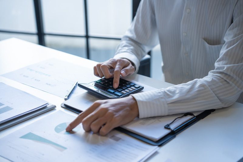 Consultant working through project cost calculations